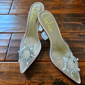 Lulu's Clear Pointed Mule Heels with Crystal Sunburst Accent